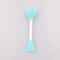 Detailed view of dual-ended silicone facial cleansing brush with bear ear design and soft scraper - Blue