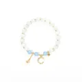 Detail of beaded bracelet with white cat-eye stones, blue beads and gold moon star charms - Gold-Blue-Star Moon