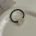 Detailed macro of white resin rose flower elastic hair tie on a decorative white ceramic plate - Pearl White