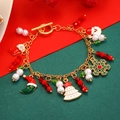 Golden Christmas charm bracelet with Santa, snowflake, and tree pendants on a festive background - Moon Pendant Style (A-535)