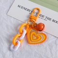 Orange and white layered heart chain keychain with a small bell and metallic ring - Orange