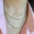 Close-up of double-layer gold titanium steel necklace with blue beads on a model - Turquoise