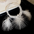 Detail view of double-layer pearl necklace with white feather accents and sparkling rhinestones - Double Layer White Pearl Feather Style