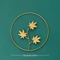 Modern 24cm golden metal wall decor featuring a triple maple leaf design in a round frame - Gold - Combined Maple Leaf / Diameter 24cm
