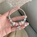 Silver beaded bracelet with pearls, pink beads, and 'Love You' heart charm in hand view - Pink Bow Bangle