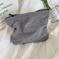 Close-up of a gray corduroy makeup bag with a top zipper on an aesthetic ins-style background - Gray