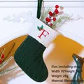 Green knit Christmas stocking with ivory cuff and red embroidered letter F for decoration - Letter F / Dark Green