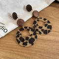 Macro shot of leopard print resin and dark wood geometric hoop earrings on a wooden table - Large Geometric Round Loop (S925 Pin-Coffee-Round)