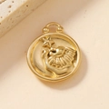 Macro shot of 18K gold plated stainless steel Leo zodiac charm with lion and star relief - Leo