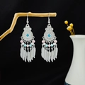Bohemian silver earrings with blue beads and feather pendants hanging on wood - E6109-23 Sapphire Feather