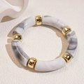 Close-up of marble acrylic links and golden beads on a minimalist beige background - Off-White