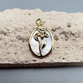 Detail of oval white shell flower pendant with gold metal frame on stone base - Style E