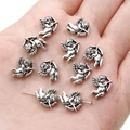 Close-up of silver cupid angel wing charms on palm for DIY jewelry making material - Cupid / 10x12mm