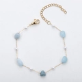 Detail of 18K gold plated bracelet with light blue irregular stones and white pearls - Artificial Pearl + Blue Quartz