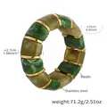 Detail view of chunky green marbled resin blocks and gold stainless steel spacers on elastic - Green