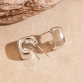Detailed view of silver square C-shaped hoop earrings on a natural stone base - Steel Pin - Silver Square