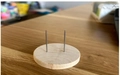 Handmade crochet doll stand with round wooden base and dual vertical metal support pins - Display Base Only