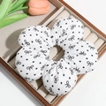 Macro view of white floral scrunchie with black bows and dots in a wooden tray - White with Bow (Approx. 14.5cm)