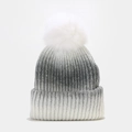 Detail of ombre grey knit beanie featuring heavy rib texture and fluffy faux fur pompom - Black and White Patchwork