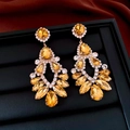 Macro shot of vintage style amber rhinestone teardrop earrings on a black display tray - Style 25# Gold Yellow (Silver Pin)