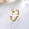 Detailed close-up of a sparkling round zircon stone set on a gold titanium steel ring - Size 5 / Gold