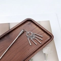 Detailed view of silver ethnic hair pin with moon crescent and tassels on wooden tray - F0742 Hair Stick-28# (Moon Strip Tassel)