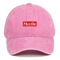 Close-up of Hustle rectangular embroidered patch on pink washed cotton baseball cap - One Size / Pink