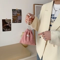 Pink corduroy drawstring storage bag with zakka label held by hand in soft light - Nude Pink