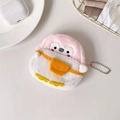 Close-up of pink and white plush penguin coin purse with silver chain on textured desk - Pink