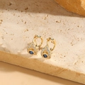 Elegant gold drop earrings with blue evil eye zircon on natural stone display - Small Evil Eye Style (ES2314-2)