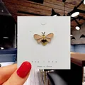 Cute enamel bee brooch pin with pink wings and yellow stripes on a white card - 112*Honey Bee Enamel Pin