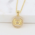 Macro detail of gold Gemini zodiac necklace pendant with sparkling zircon accents - Gemini