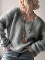 Close-up of soft grey-blue V-neck knit sweater with a brown beaded necklace detail - S / Gray