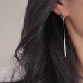 Close-up of a silver knot tassel earring worn by a model in a minimalist French style - Sd136 Silver Knotted Long Earrings / Titanium Steel