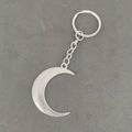 Vintage Sonne und Mond Schlüsselanhänger aus Silber auf grauem strukturiertem Grund - Antiksilber Mond