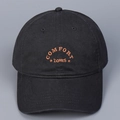 Close-up of orange COMFORT ZONES embroidery on a premium black cotton baseball cap - M (56-58cm) / Black