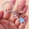 Fashionable shell starfish keychain with pink conch and pearl accents on a silver keyring - Blue Shell Starfish