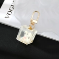 Detail of white resin bear inside clear cube pendant with glitter and gold D-ring hook - White Bear