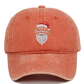 Close-up of Santa Claus embroidery and Merry Christmas text on washed orange cotton cap - Coral