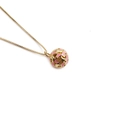 Golden necklace featuring a sphere pendant with pink enamel star details on white background - Pink Crescent