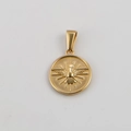 Detailed macro view of a gold-plated circular pendant featuring an embossed dove motif - Gold-Round Peace Dove