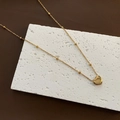 Close-up of golden heart pendant engraved with Real Love on a bead snake chain - 01-I 18 Titanium Steel Heart Necklace Gold