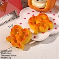 Cute golden resin pretzel hair accessory model with realistic bread texture and glossy finish - Heart Roll Bread