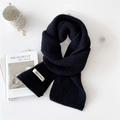 Solid black knitted thick winter scarf with Voice Choo label on a white aesthetic background - Black