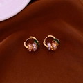 Detail of gold hoops with pink, purple and green zircon stones on brown velvet - Hoop Buckle-Gold-Multicolor(Green/Purple/Pink)