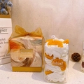 Scented candle gift box featuring cream and orange slices in a jar with gold bow packaging - Orange