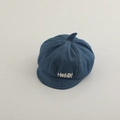 Detail of blue denim newsboy hat featuring white stitching and Hello smile embroidery - 50cm 1-4 Years / Blue