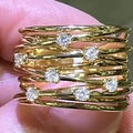 Detail of multi-layer gold twisted ring band with seven micro-pave white zircon stones - US 7 / Gold