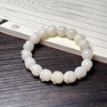 White Bodhi seed bracelet with cat paw carving on a traditional wooden background - White Jade Bodhi Cat Paw