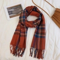 Classic orange and blue plaid scarf with long tassels laid on a minimalist white backdrop - Little Red Riding Hood Santa